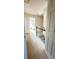 Upstairs hallway with a black handrail and view into a bedroom at 771 Franklin Mill Trce, Loganville, GA 30052