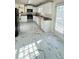 Bright kitchen featuring white cabinets, stainless steel appliances, and stylish white marble-patterned flooring at 771 Franklin Mill Trce, Loganville, GA 30052