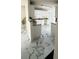 Bright kitchen with white cabinets, new marble-patterned tile flooring, and plenty of counter space at 771 Franklin Mill Trce, Loganville, GA 30052