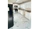 Bright kitchen featuring white cabinets, stainless steel appliances, and stylish white marble-patterned flooring at 771 Franklin Mill Trce, Loganville, GA 30052