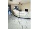 Bright living area with marble-patterned tile floors, a ceiling fan, and a fireplace with white furniture at 771 Franklin Mill Trce, Loganville, GA 30052