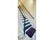 Stairway featuring black stairs, white railings, and white marble-patterned flooring at 771 Franklin Mill Trce, Loganville, GA 30052