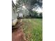 A home featuring a modest backyard with some greenery and large trees at 1253 Gus Thornhill Jr Dr, Atlanta, GA 30344