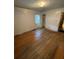 This bedroom features hardwood flooring and a window allowing natural light to brighten the space at 1253 Gus Thornhill Jr Dr, Atlanta, GA 30344
