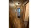 Hallway featuring wood flooring, wood paneling, and access to rooms and other areas at 1253 Gus Thornhill Jr Dr, Atlanta, GA 30344