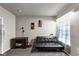 Versatile bedroom/flex space with a futon and desk area, perfect for guests or a home office at 1332 Worcester Trl, Mcdonough, GA 30253