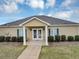 Clubhouse with a covered entrance, white columns, and manicured landscaping at 1332 Worcester Trl, Mcdonough, GA 30253