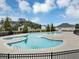 Community pool with a fenced-in area, sunning areas, and lush landscaping at 1332 Worcester Trl, Mcdonough, GA 30253