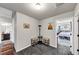Bright hallway with carpet flooring, decor and open doorways to the bathroom and bedroom at 1332 Worcester Trl, Mcdonough, GA 30253
