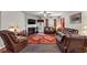 Cozy living room featuring a fireplace, comfortable seating, and a large area rug at 1332 Worcester Trl, Mcdonough, GA 30253