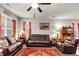 Spacious living room with plush leather seating, decorative accents, and plenty of natural light at 1332 Worcester Trl, Mcdonough, GA 30253