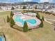 Aerial view of community pool featuring a fenced area, a covered patio and a -friendly wading area at 1332 Worcester Trl, Mcdonough, GA 30253