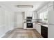 Functional kitchen featuring white cabinetry, appliances, and tile flooring at 1360 Cypress Ridge Cir, Stone Mountain, GA 30083