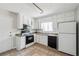 Bright kitchen with white cabinets, appliances, and tile floors, offering practical charm at 1360 Cypress Ridge Cir, Stone Mountain, GA 30083