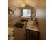 A cozy bedroom with a queen bed, a decorative chandelier, and a makeup vanity with perfumes at 2742 Snapfinger Manor, Decatur, GA 30035
