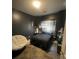 Bedroom with dark painted walls, comfortable bed, window with blinds, and neutral decor at 2742 Snapfinger Manor, Decatur, GA 30035