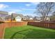 Fully fenced backyard with a well maintained lawn ensures a secure and private outdoor space at 9893 Colchester St, Douglasville, GA 30135