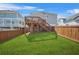 Enjoy this spacious backyard with lush lawn, a wood fence, and a deck for outdoor fun and gatherings at 9893 Colchester St, Douglasville, GA 30135