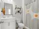 Cozy bathroom features white vanity, modern mirror, updated shower, and decorative shelving accents at 9893 Colchester St, Douglasville, GA 30135