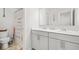 Bathroom featuring a double vanity with a large mirror and unique decor on the walls at 9893 Colchester St, Douglasville, GA 30135
