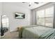 Serene bedroom with a large window, modern decor, plush carpet, and ample natural light at 9893 Colchester St, Douglasville, GA 30135