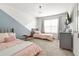 Charming bedroom featuring two twin beds, soft pink accents, and a bright, sunny window at 9893 Colchester St, Douglasville, GA 30135
