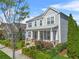 Charming two-story home featuring a welcoming front porch and beautifully landscaped front yard with mature trees at 9893 Colchester St, Douglasville, GA 30135