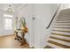 Bright foyer with hardwood floors, a stylish console table, and a staircase at 9893 Colchester St, Douglasville, GA 30135