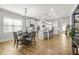 Open-concept kitchen with white cabinets, granite counters, stainless steel appliances, and a center island with barstool seating at 9893 Colchester St, Douglasville, GA 30135