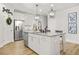 Kitchen island with white cabinets, granite countertops, pendant lighting, stainless steel appliances, and modern fixtures at 9893 Colchester St, Douglasville, GA 30135