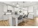Bright kitchen with white cabinets, granite counters, stainless steel appliances, and a large center island with barstool seating at 9893 Colchester St, Douglasville, GA 30135