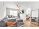 Cozy living room featuring a sectional sofa, hardwood floors, and a mounted television at 9893 Colchester St, Douglasville, GA 30135