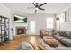 Inviting living room with a stone fireplace, modern furnishings, stylish decor, and lots of natural light at 9893 Colchester St, Douglasville, GA 30135