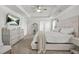 This spacious main bedroom has a TV, ceiling fan, and tray ceilings for a relaxed and modern space at 9893 Colchester St, Douglasville, GA 30135