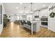 Spacious open-concept layout with a kitchen featuring an island, dining area, and cozy living room with a fireplace at 9893 Colchester St, Douglasville, GA 30135