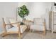 Comfortable sitting area features stylish chairs with wood frames and a small table with a large plant at 9893 Colchester St, Douglasville, GA 30135