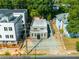 Aerial view of home situated between other buildings, with a paved driveway, and lush green trees at 175 Moreland Se Ave, Atlanta, GA 30316