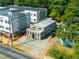 Aerial view of home situated between other buildings, with a paved driveway, and lush green trees at 175 Moreland Se Ave, Atlanta, GA 30316