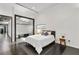 Bright bedroom with sleek hardwood floors, modern design, and frosted glass accent wall for privacy at 175 Moreland Se Ave, Atlanta, GA 30316