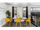 Modern dining room featuring a wooden table with vibrant yellow chairs and natural lighting at 175 Moreland Se Ave, Atlanta, GA 30316