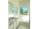 Bright bathroom with a granite vanity top, soaking tub and a large sunny window at 203 Sea Marsh Ct, Fayetteville, GA 30215