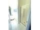 Bright bathroom featuring a glass enclosed shower, tiled flooring, and a modern vanity with ample counter space at 203 Sea Marsh Ct, Fayetteville, GA 30215