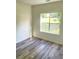 Bright bedroom with large window and laminate wood-look floors at 203 Sea Marsh Ct, Fayetteville, GA 30215