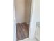 Walk-in closet featuring wood-look floors, neutral paint, and a bright, organized storage space at 203 Sea Marsh Ct, Fayetteville, GA 30215