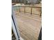 Spacious wooden deck overlooking community tennis courts and playground with wooden railing, perfect for outdoor relaxation at 203 Sea Marsh Ct, Fayetteville, GA 30215