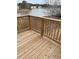 Wooden deck with railing overlooking a serene lake surrounded by trees, perfect for enjoying nature views at 203 Sea Marsh Ct, Fayetteville, GA 30215