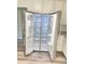 Stainless steel refrigerator with open doors against white kitchen cabinets at 203 Sea Marsh Ct, Fayetteville, GA 30215