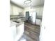Modern kitchen with stainless steel appliances, granite countertops, and sleek white cabinetry at 203 Sea Marsh Ct, Fayetteville, GA 30215