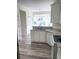 Well-lit kitchen featuring granite countertops, white cabinets, and modern appliances for a seamless cooking experience at 203 Sea Marsh Ct, Fayetteville, GA 30215