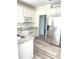 Modern kitchen with white cabinets, stainless steel appliances, granite countertops, and wood-look floors at 203 Sea Marsh Ct, Fayetteville, GA 30215